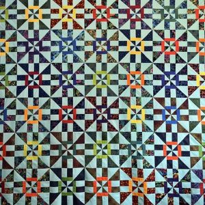 The Whirlwind Quilt Pattern is a colorful disappearing pinwheel block with a twist.